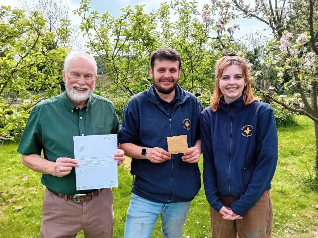 Roger Leivers (Local WW2 Historian and Author), Oscar (Nursery Manager) and Katie (Assistant Nursery Manager) of Godmanchester, Cambridgeshire, England with their Hackberry seeds.